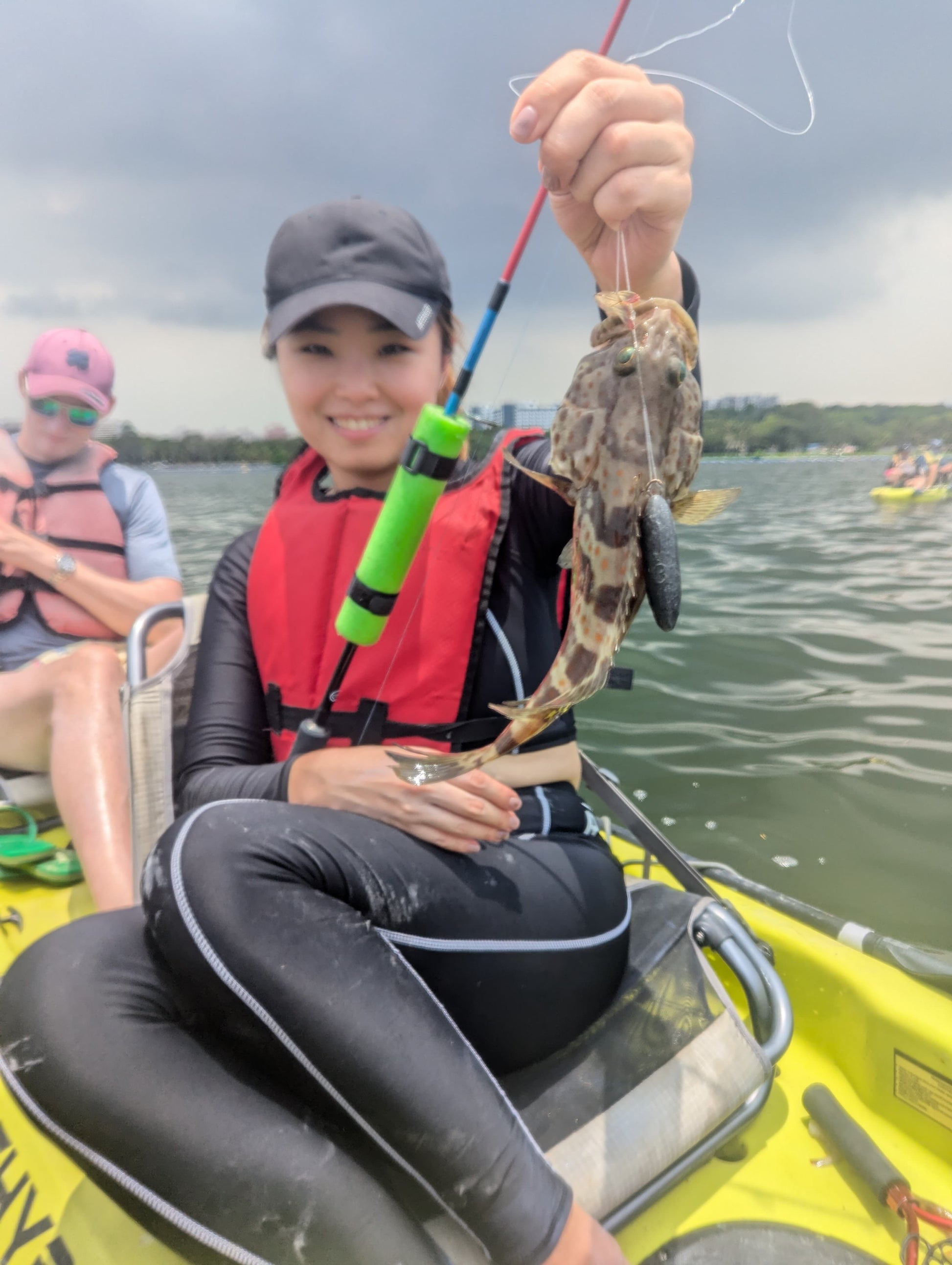 Lady catches grouper on purehybridz kayak fishing tour in Singapore, Pulau Ubin