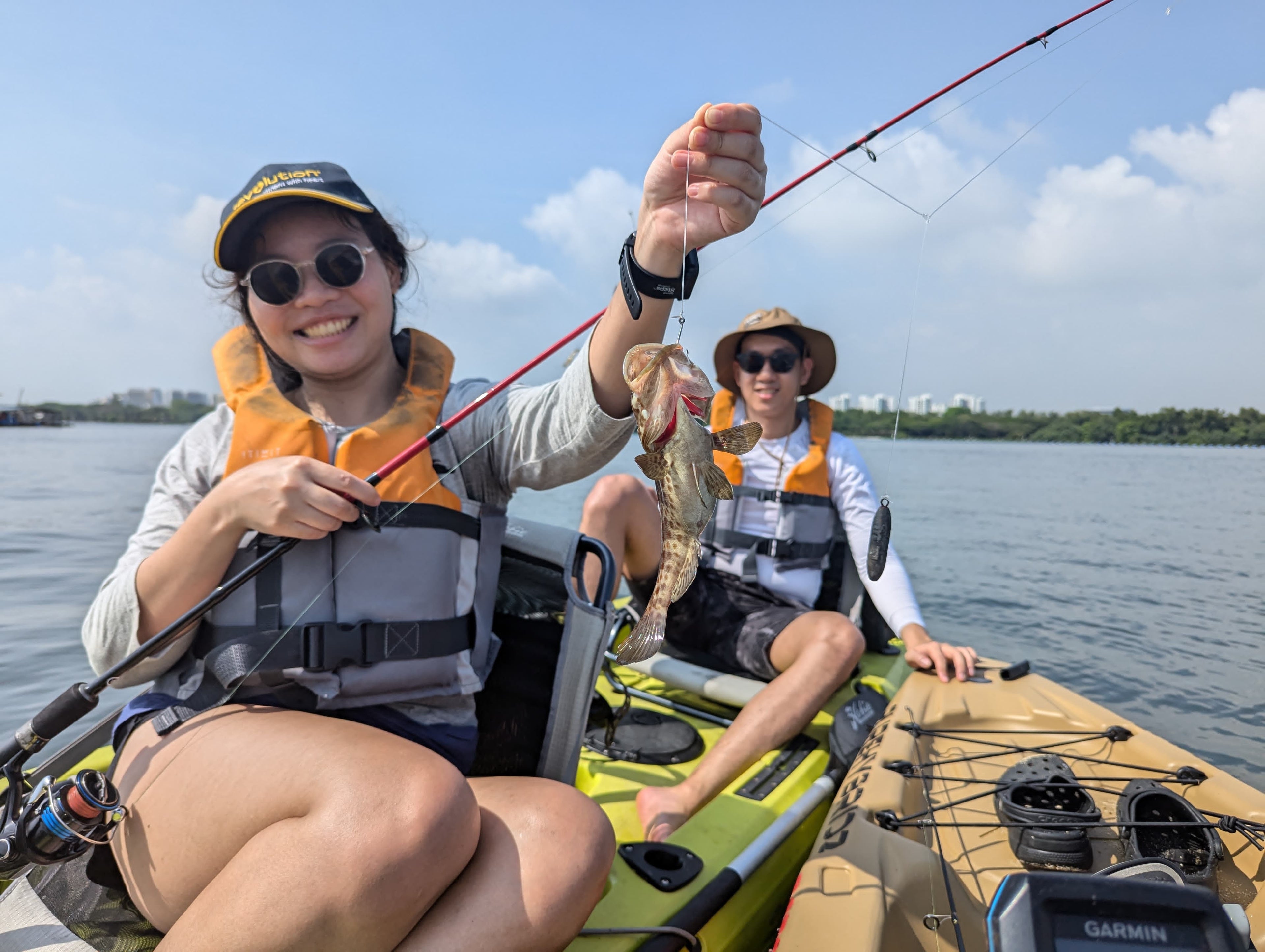 Lady catches grouper on purehybridz kayak fishing tour in Singapore, Pulau Ubin