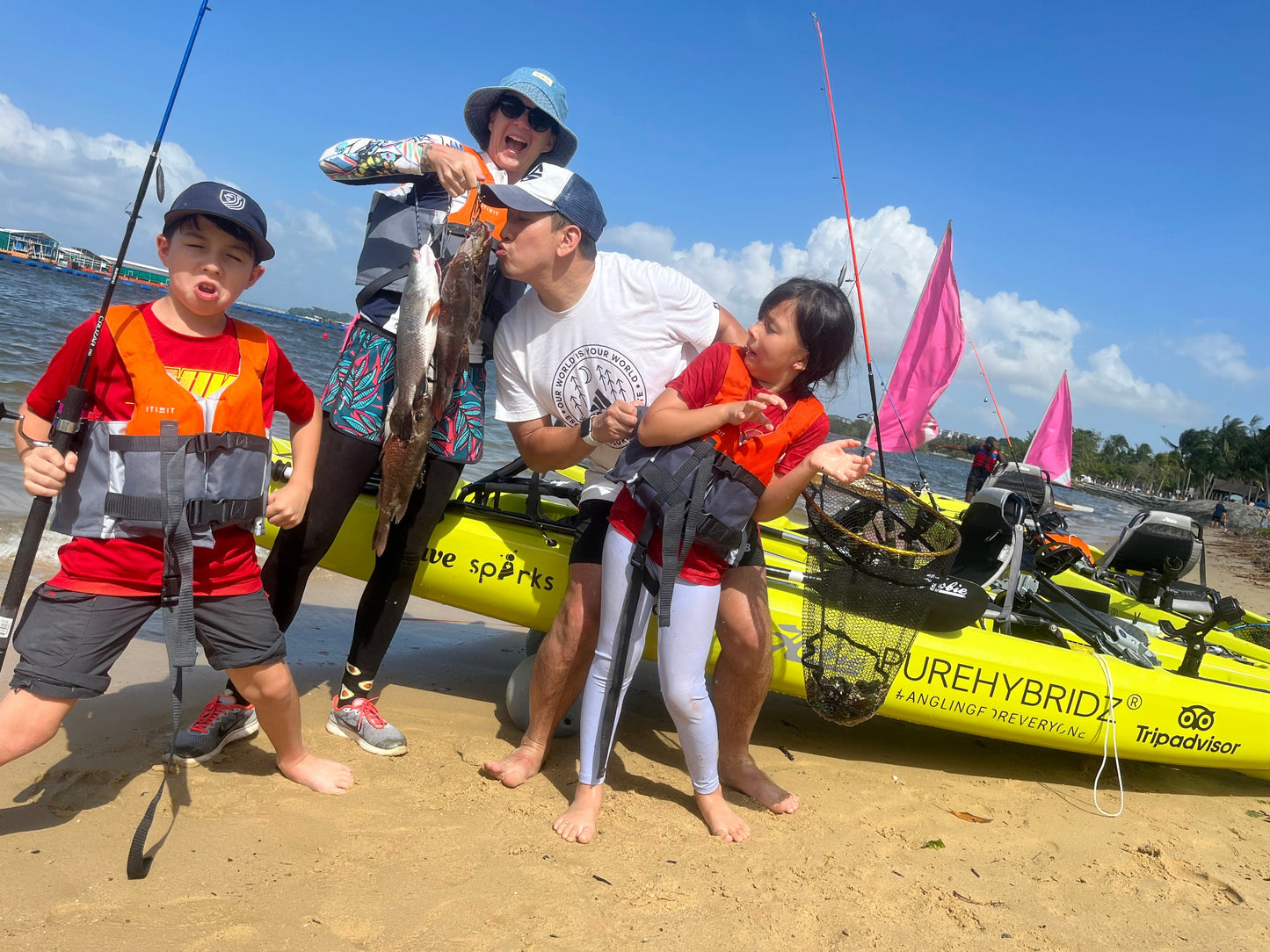 Youtubers Wanderlust vlog showing off their catch on Purehybridz Kayak Fishing Tours in Pasir Ris