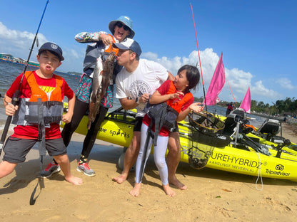 Youtubers Wanderlust vlog showing off their catch on Purehybridz Kayak Fishing Tours in Pasir Ris