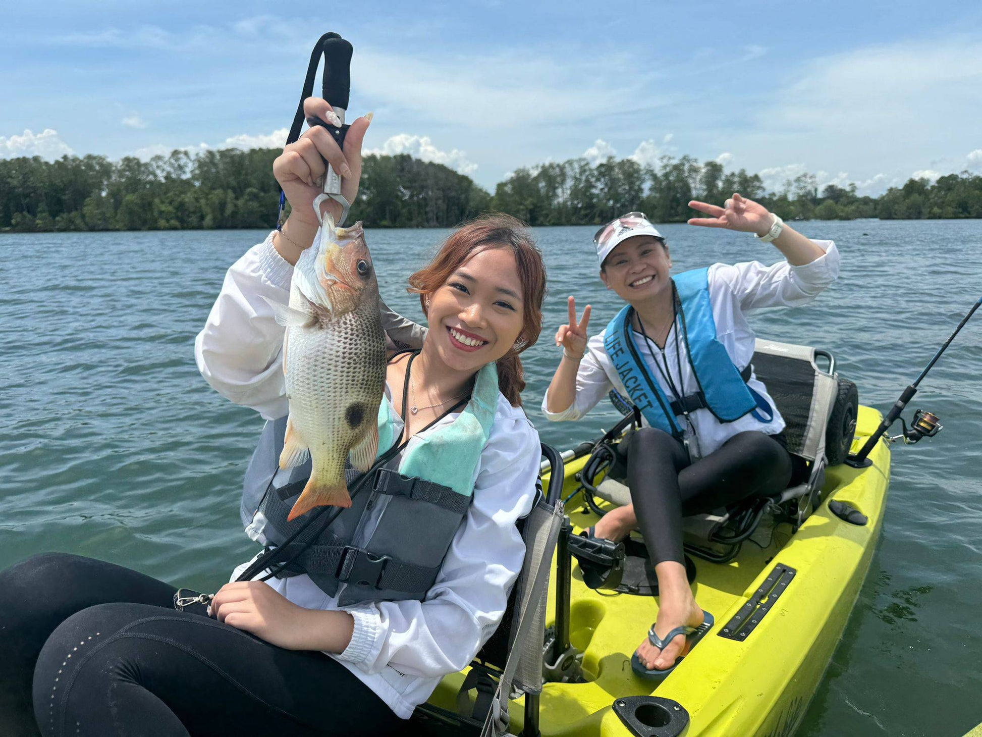 Influencer Sarah Lim catches a golden snapper on Purehybridz Kayak Fishing Tour in Pulau Ubin 