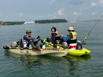 Kayak fishing guide Dom helps guests take photos of their catch and shows it off to them