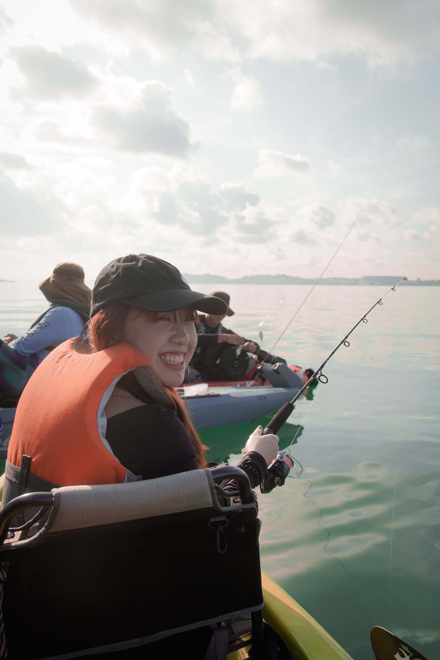 Lady angler enjoying the sea breeze while fishing on Purehybridz Kayak Fishing Tours in Pasir Ris